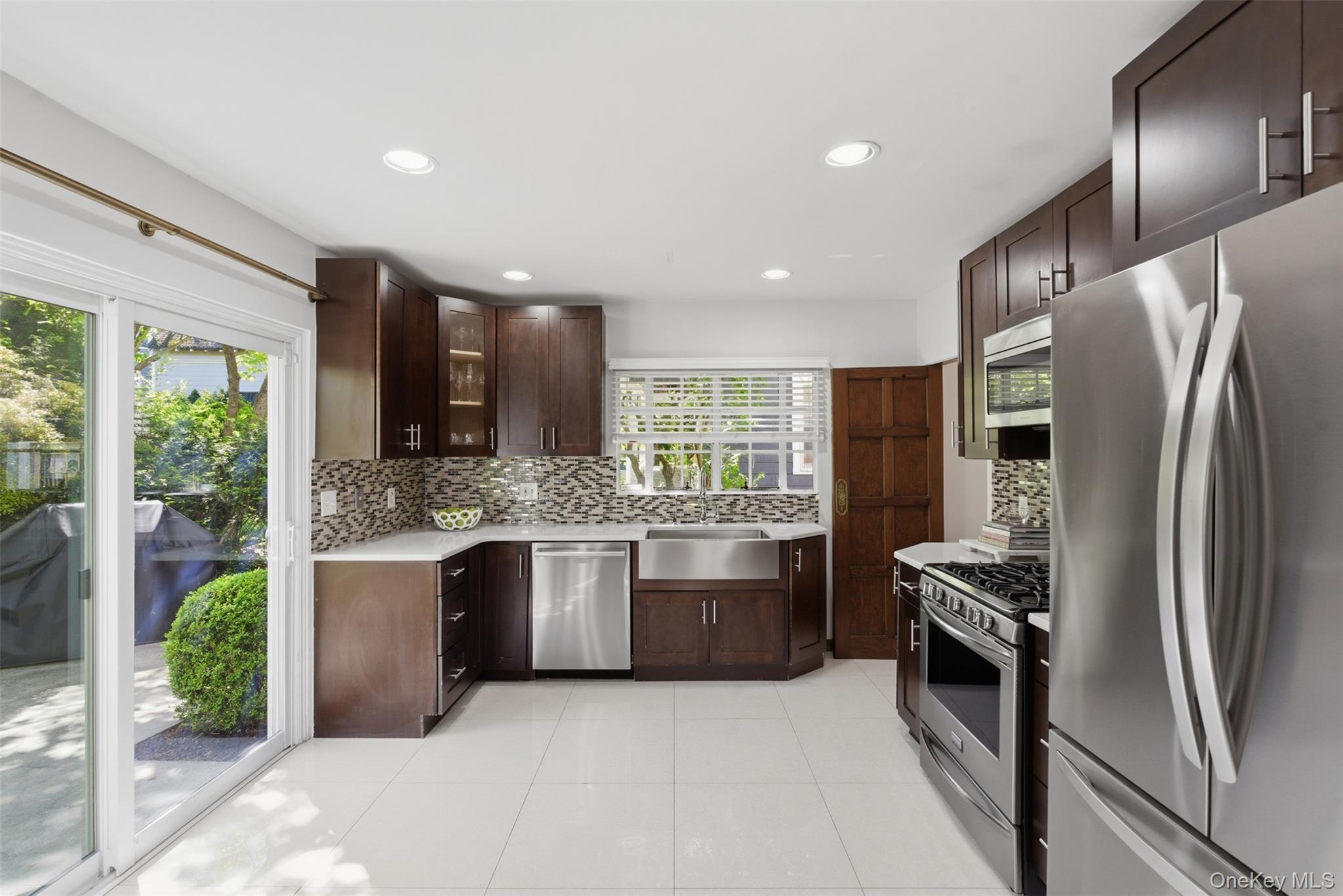 15 Kingsbury Road New Rochelle, NY 10804 - Photo 10 of 30 a kitchen with stainless steel appliances granite countertop a refrigerator and a sink