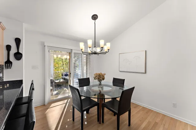 a dining room with furniture a chandelier and window