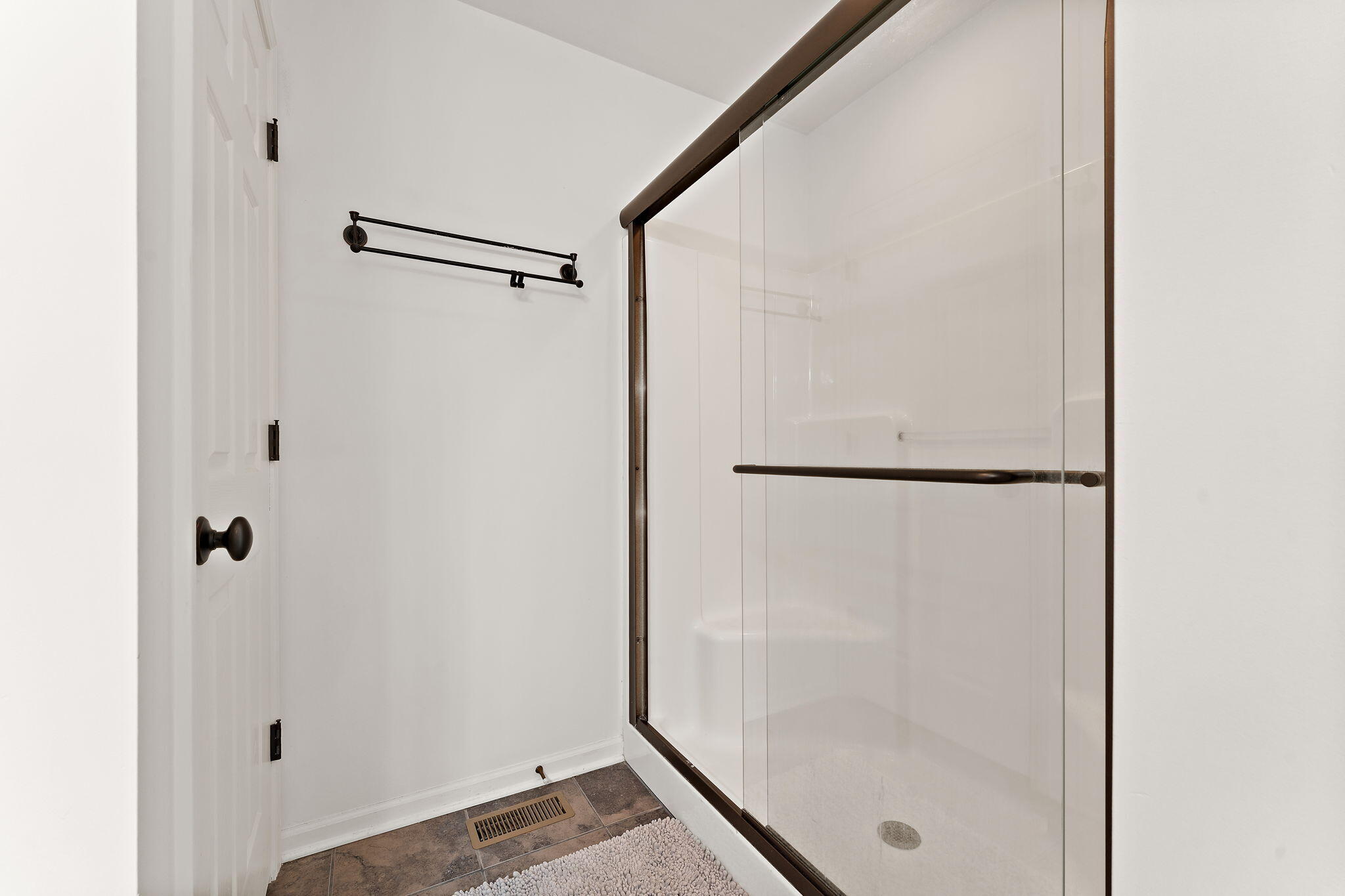 2335 Legend Circle Chesterton, IN 46304 - Photo 16 of 33 a bathroom with a glass shower door