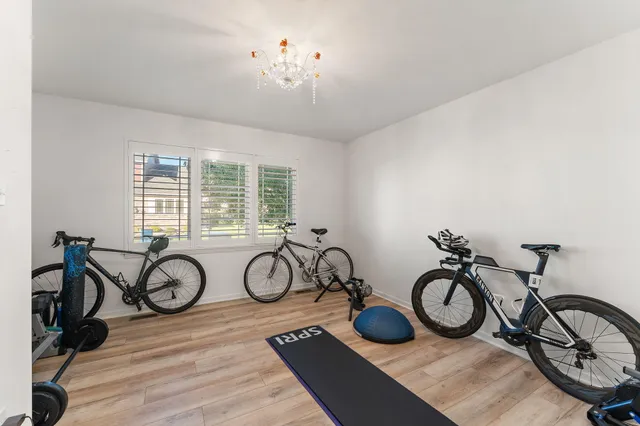 a bathroom with a granite countertop sink a toilet a mirror and shower