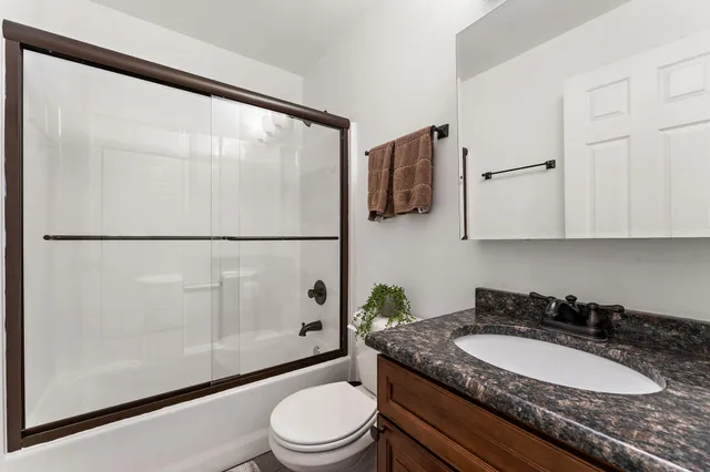 a view of a hallway with couch and windows