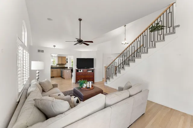 a living room with furniture and a chandelier