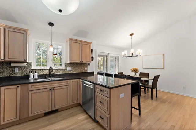 a kitchen with white cabinets sink and stove