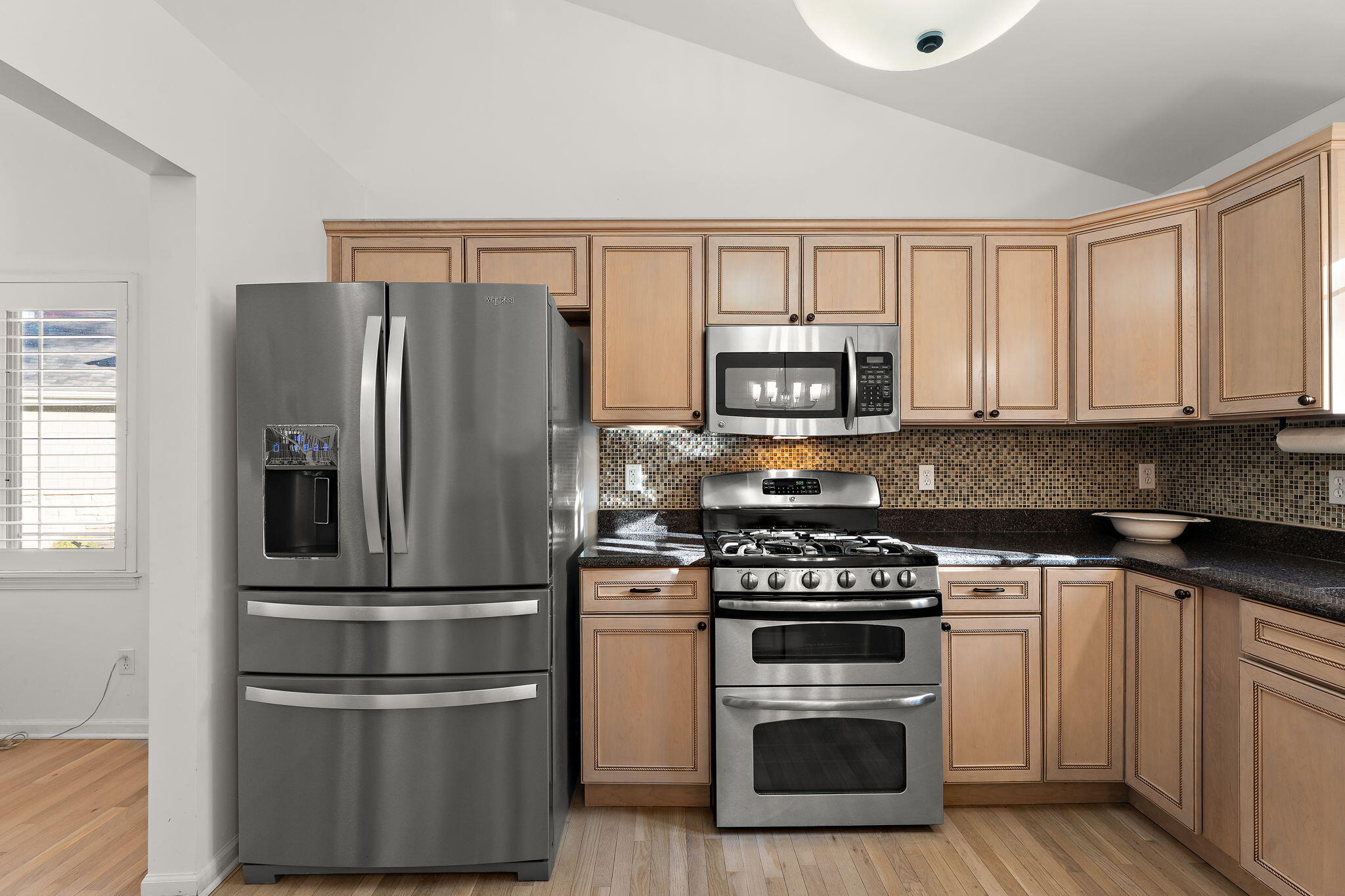 2335 Legend Circle Chesterton, IN 46304 - Photo 8 of 33 a kitchen with cabinets stainless steel appliances and wooden floor