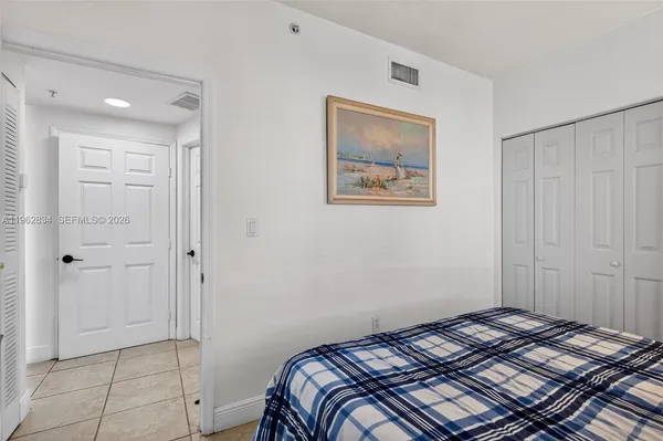 a bedroom with a bed and the view of bathroom