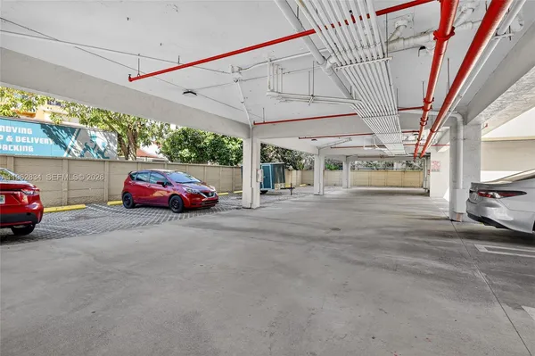 a view of a cars park in front of a building