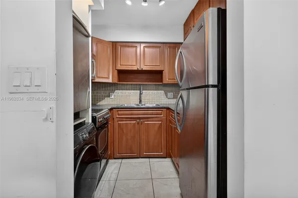 a utility room with cabinets washer and dryer