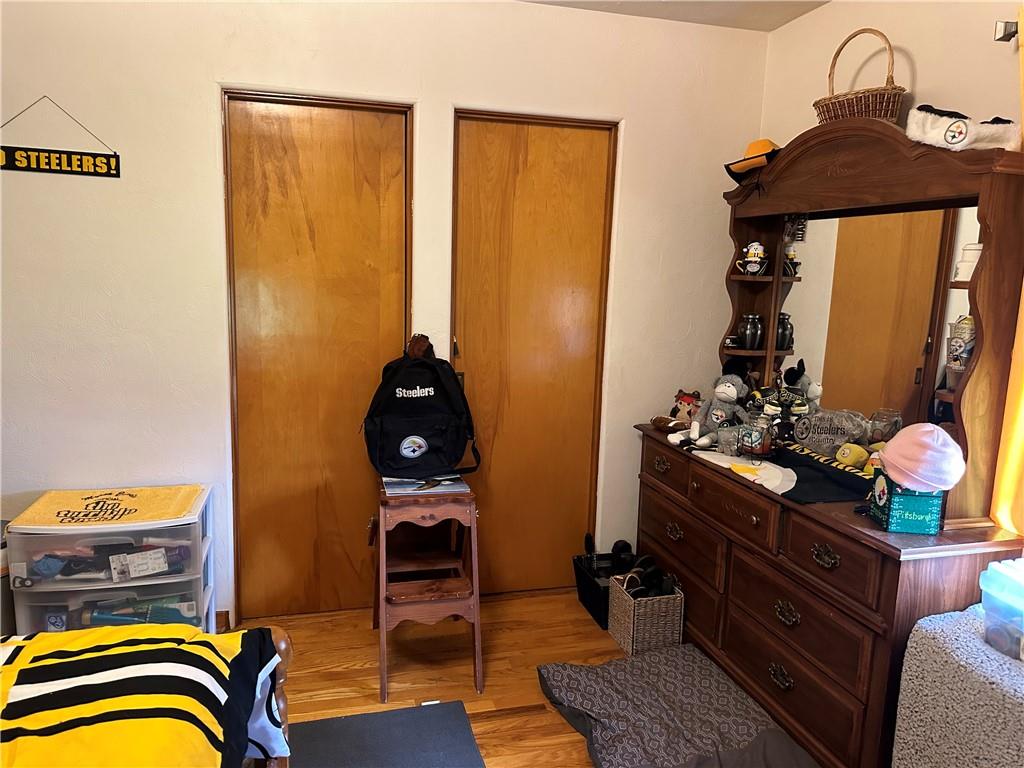 704 Middle 1st Street Rural Valley, PA 16249 - Photo 16 of 23 a bedroom with a bed and wooden floor