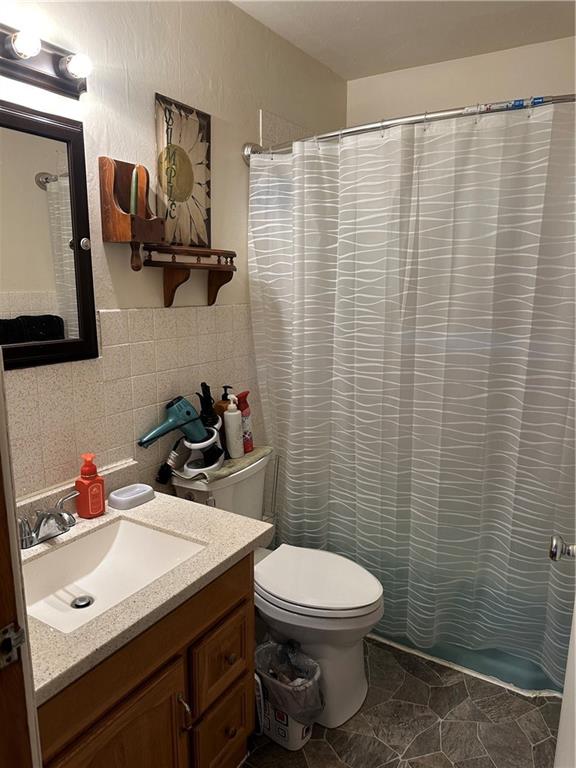 704 Middle 1st Street Rural Valley, PA 16249 - Photo 19 of 23 a bathroom with a sink a toilet and shower curtain