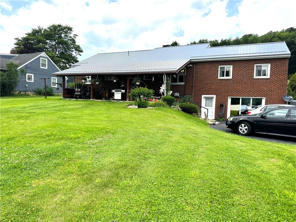 704 Middle 1st Street Rural Valley, PA 16249 - Photo 21 of 23 a front view of a house with a garden and porch