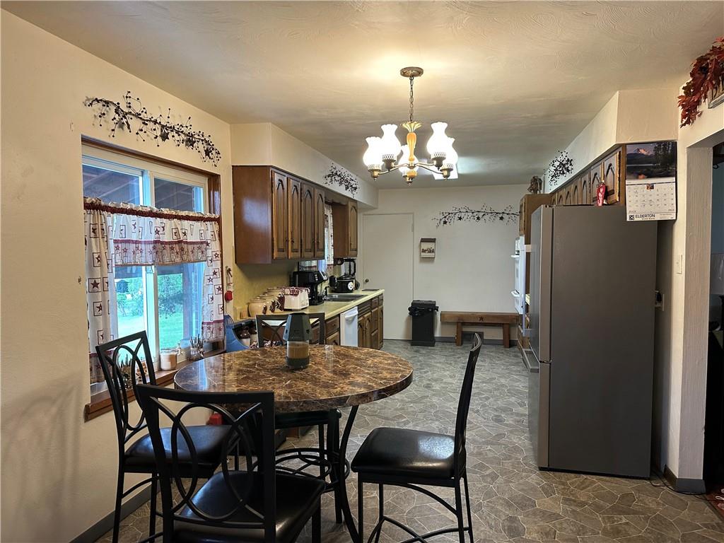 704 Middle 1st Street Rural Valley, PA 16249 - Photo 6 of 23 a view of a dining room with furniture and chandelier
