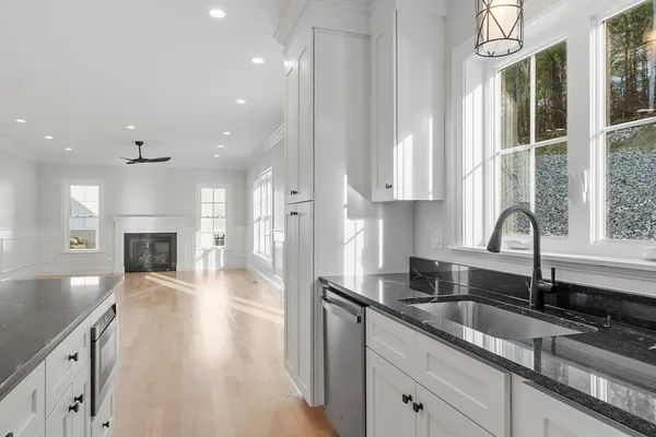 a kitchen with granite countertop a sink stainless steel appliances and cabinets