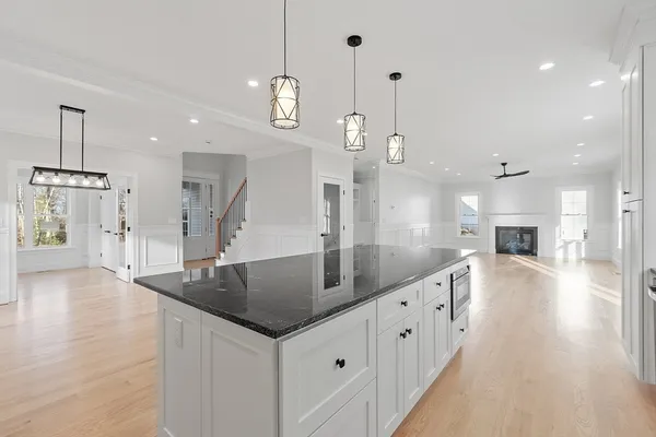 a large kitchen with kitchen island a large island a sink stainless steel appliances and cabinets