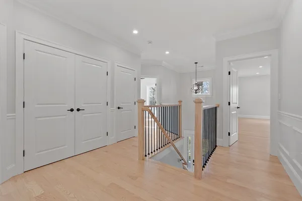 a view of a hallway with wooden cabinets