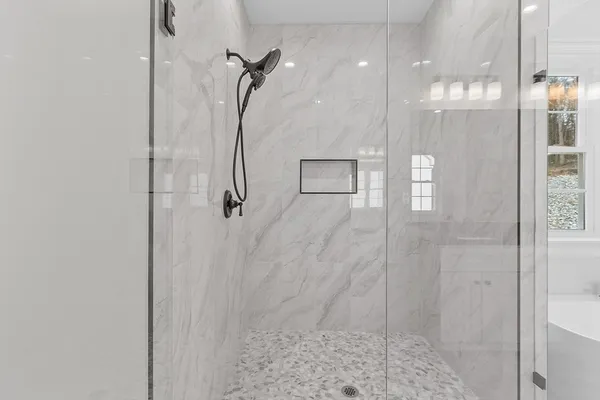 a bathroom with a glass shower door