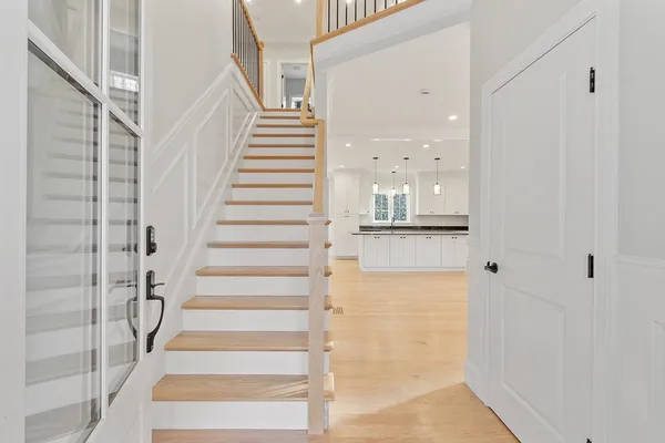 a view of staircase with white walls and windows