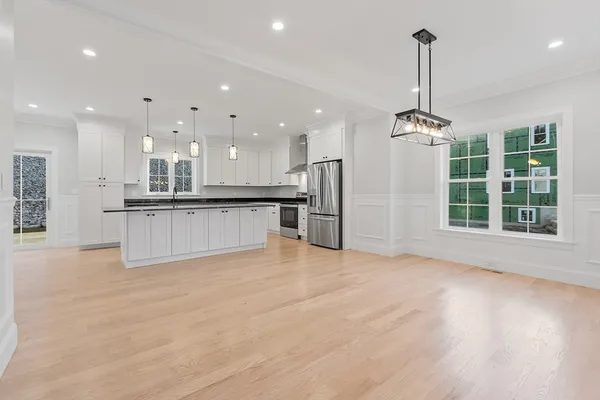 a view of kitchen with refrigerator and window
