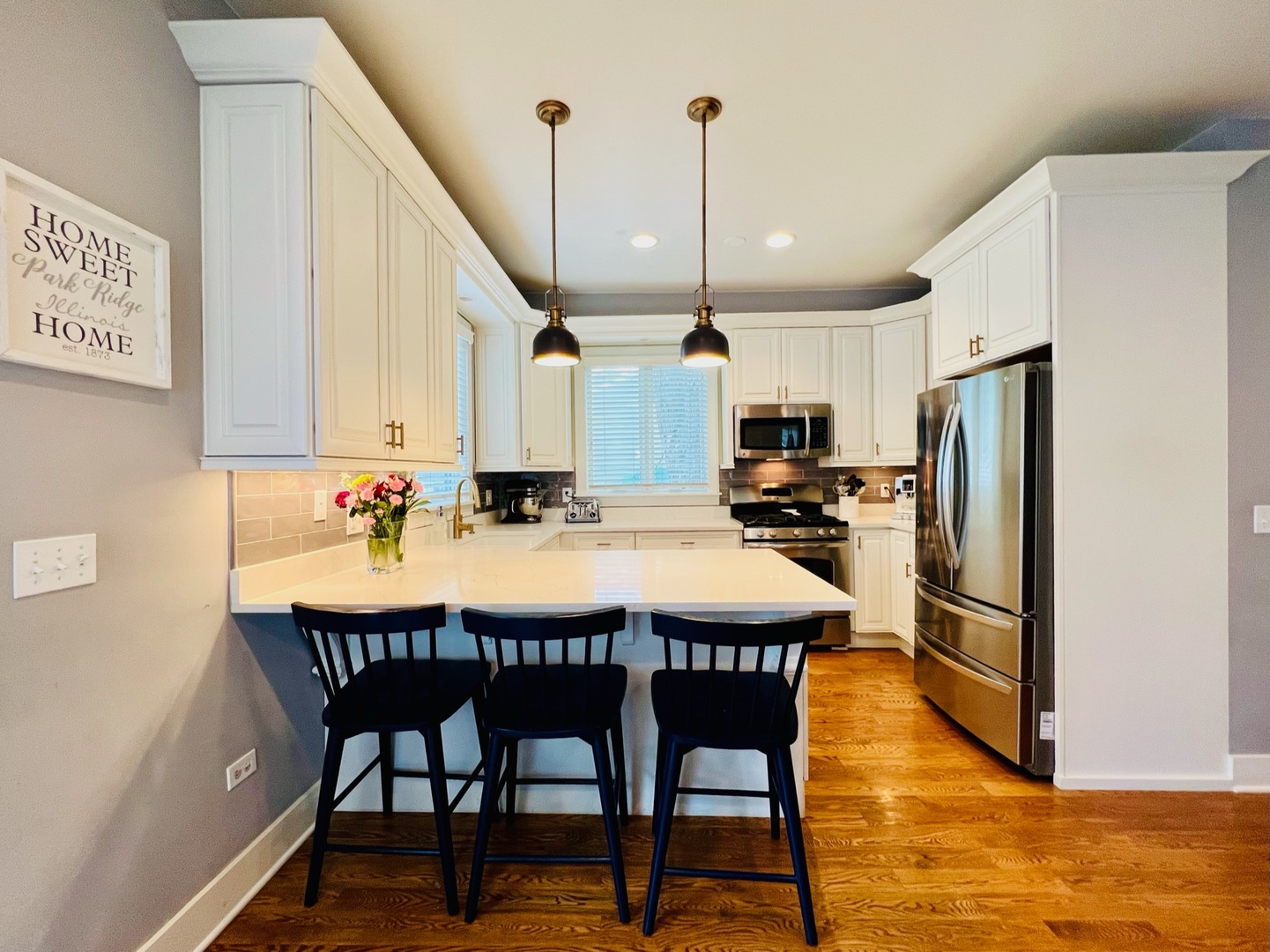 1105 Harrison Street Park Ridge, IL 60068 - Photo 7 of 29 a kitchen with stainless steel appliances kitchen island granite countertop a refrigerator a stove a sink dishwasher with a dining table and chairs