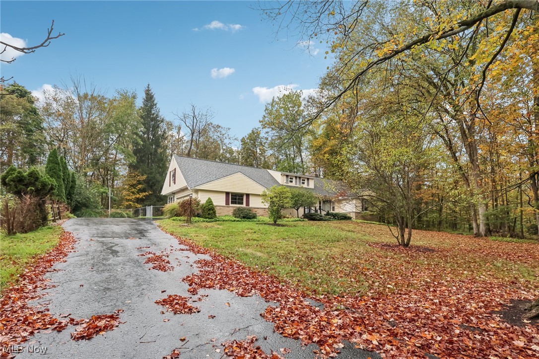 33300 South Woodland Road Cleveland, OH 44124 - Photo 2 of 50 View of front of house with asphalt driveway and a front yard