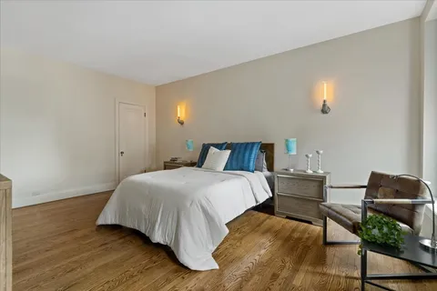 a bedroom with a bed and chair