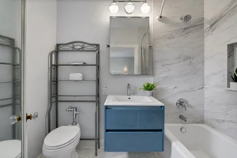 a bathroom with a sink toilet and shower