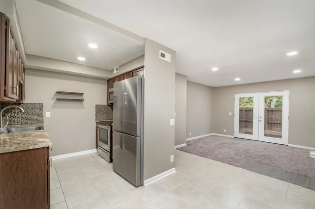 a view of a electric appliances in kitchen and an empty room