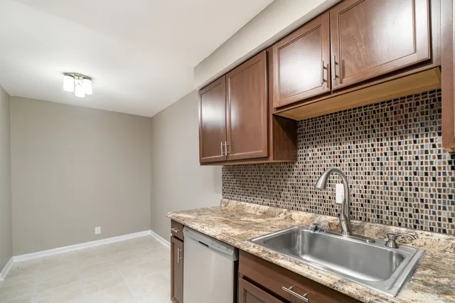 a kitchen with a sink and cabinets