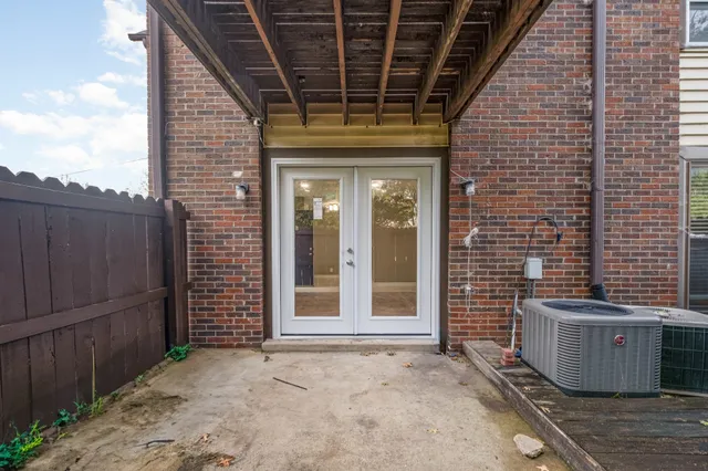 a view of a door of the house and wooden deck
