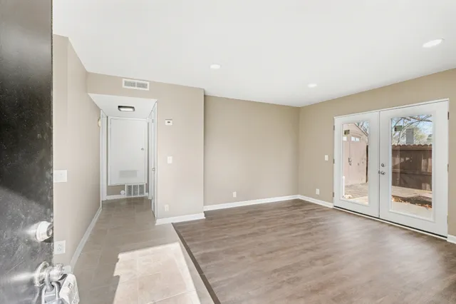 wooden floor in an empty room with a window