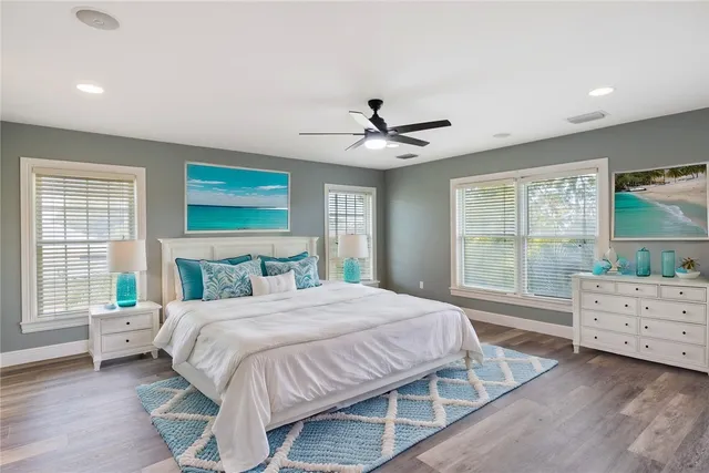 a bedroom with a bed chandelier and a window