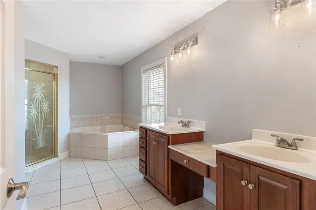 a bathroom with a tub sink and mirror
