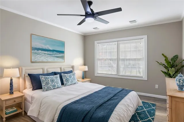 a bedroom with a large bed and a window