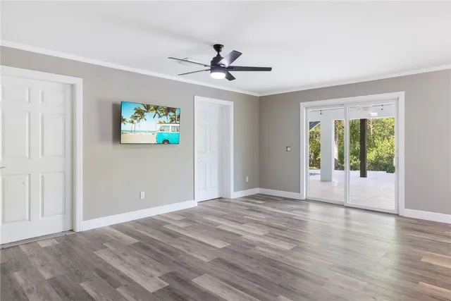 a view of empty room with wooden floor