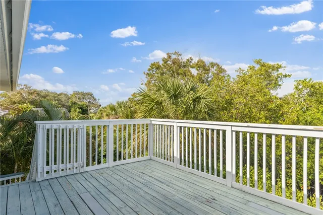 a balcony with wooden floor and fence