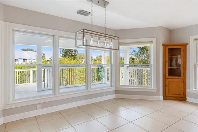 a view of an entryway with a floor to ceiling window and a couch