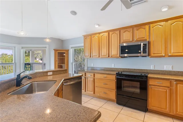 a kitchen with stainless steel appliances granite countertop a sink stove and microwave