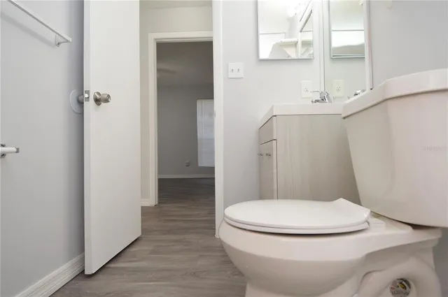 a view of patio with chairs and table under an umbrella with a barbeque