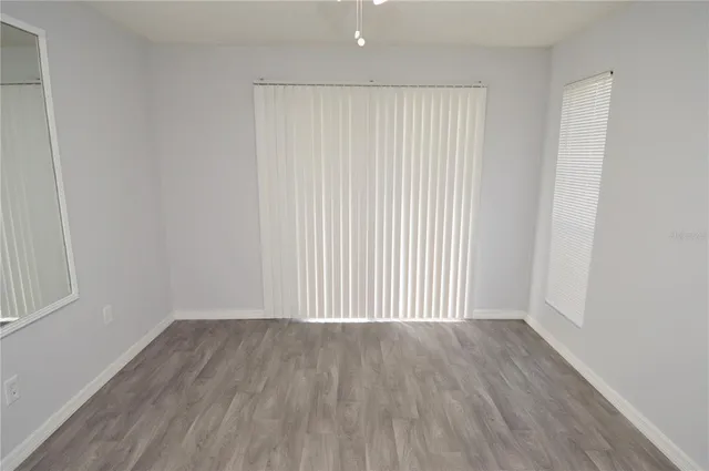 a view of a patio with table and chairs under an umbrella