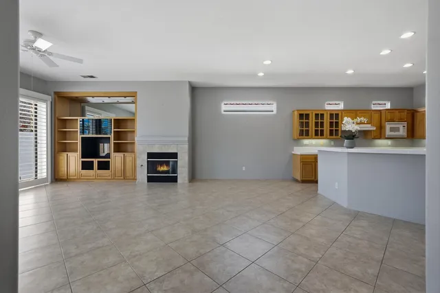an empty room with a kitchen and a sink
