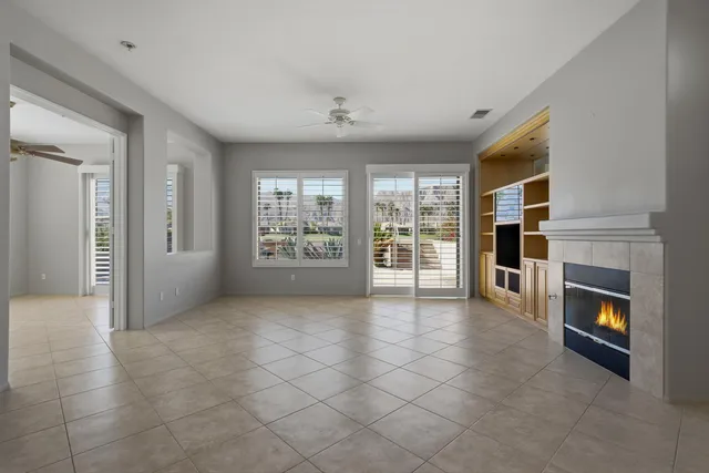 a view of an empty room with furniture and a fireplace