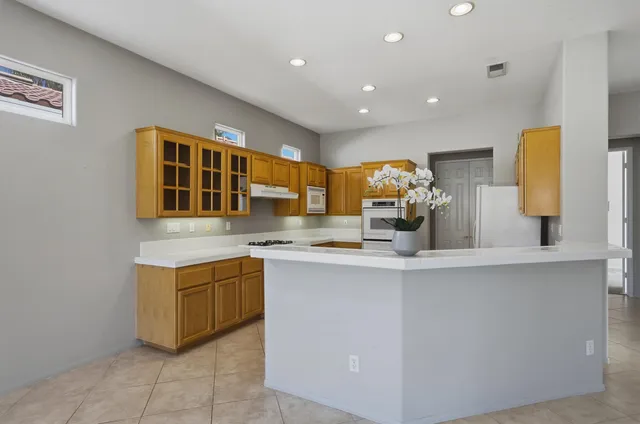 a kitchen with stainless steel appliances granite countertop a sink and cabinets