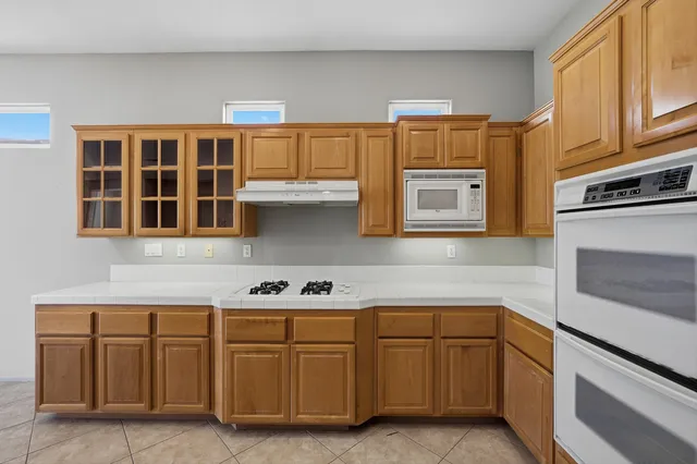 a kitchen with cabinets and appliances