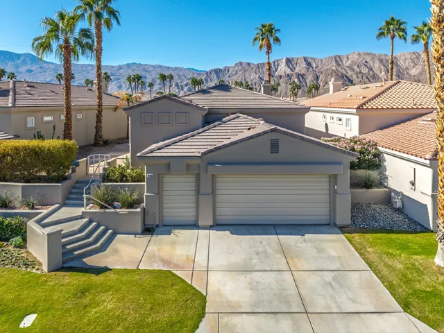 a view of a patio with table and chairs potted plants