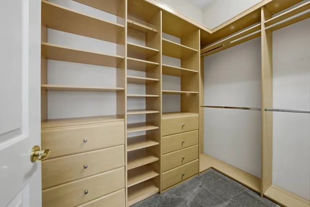 a view of walk in closet with empty racks