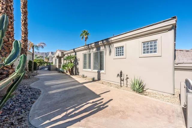 a view of a house with backyard and sitting area