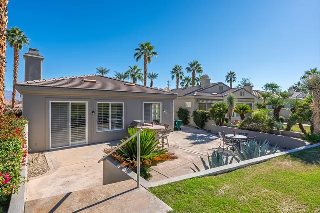 a view of a house with backyard porch and sitting area