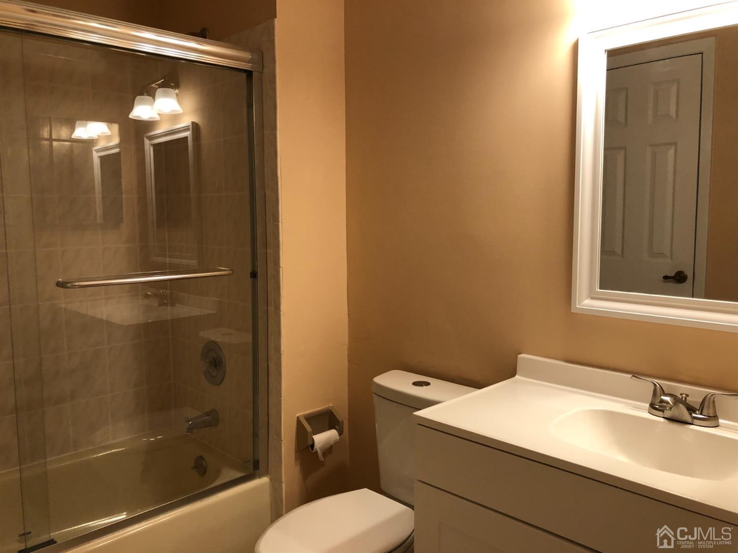 7706 Hana Road Edison, NJ 08817 - Photo 15 of 28 a bathroom with a sink a toilet and shower