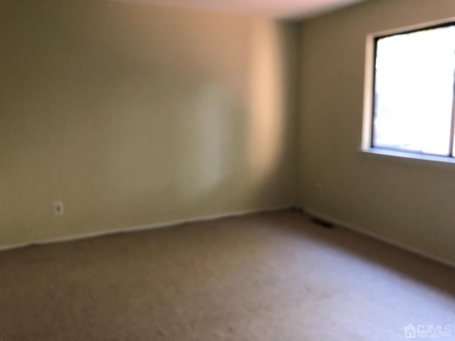 7706 Hana Road Edison, NJ 08817 - Photo 16 of 28 an empty room with a window