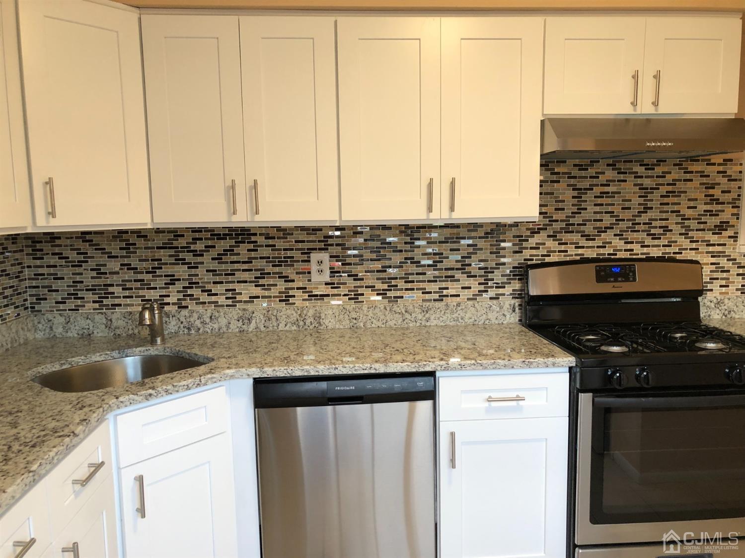 7706 Hana Road Edison, NJ 08817 - Photo 3 of 28 a kitchen with granite countertop a sink and a stove