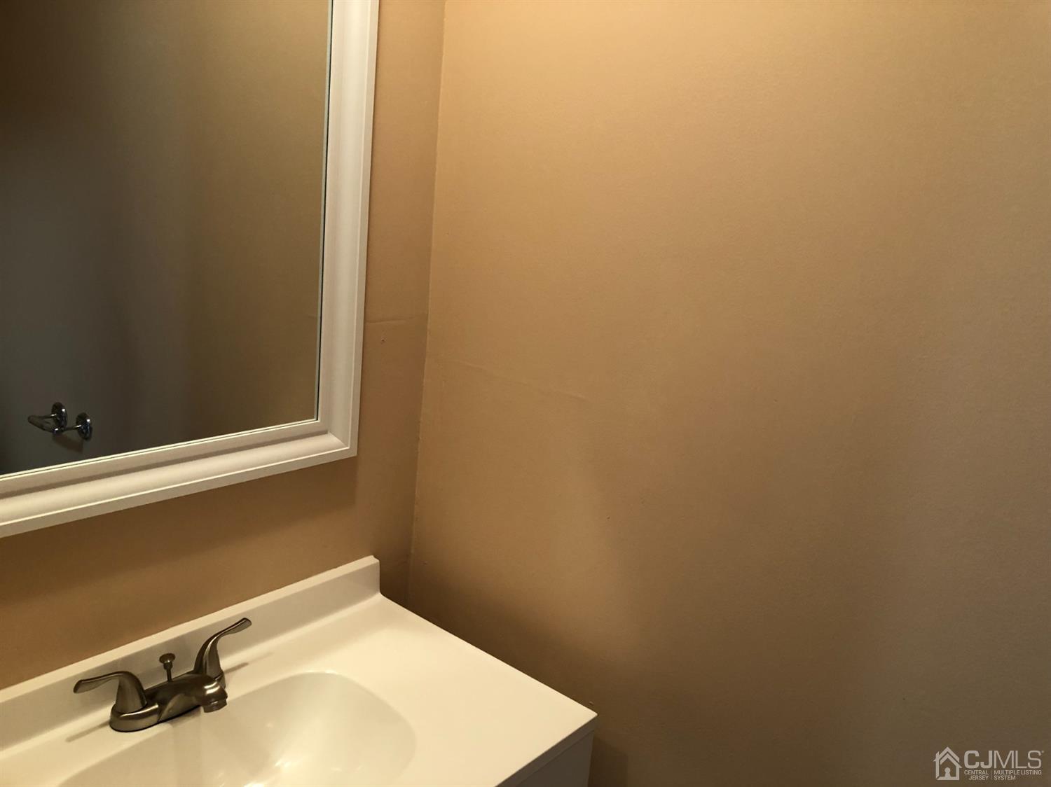 7706 Hana Road Edison, NJ 08817 - Photo 9 of 28 a bathroom with a sink and vanity
